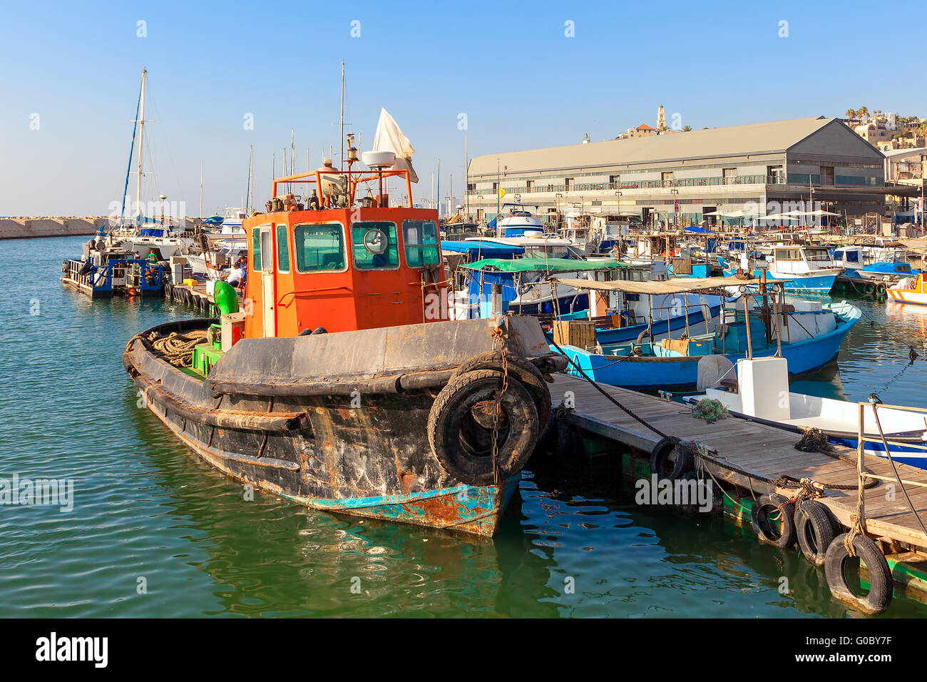 Old colorful rust fisherman boat tied to a pier in port of old Jaffa in  Israel Stock Photo - Alamy