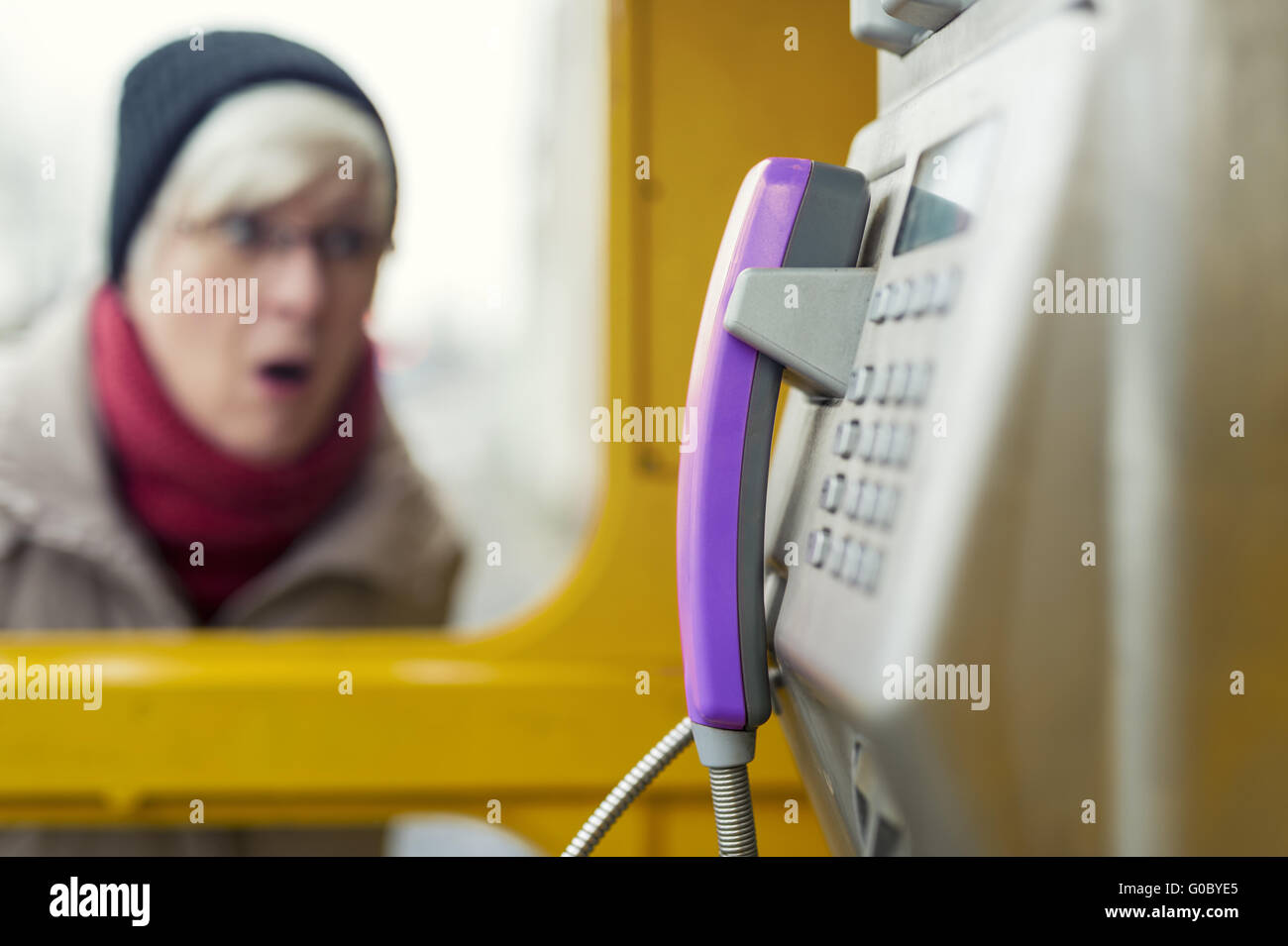 Senior tailback at a phone booth Stock Photo