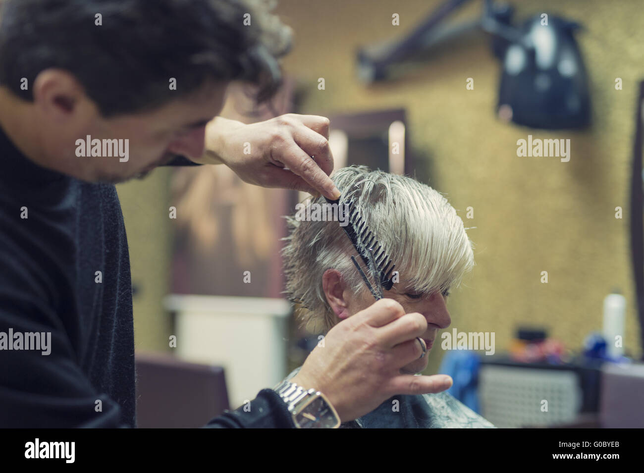 Senior at the hairdresser Stock Photo