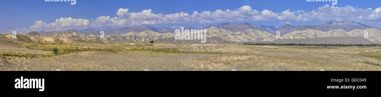 Scenic panorama of green grasslands in Kyrgyzstan Stock Photo
