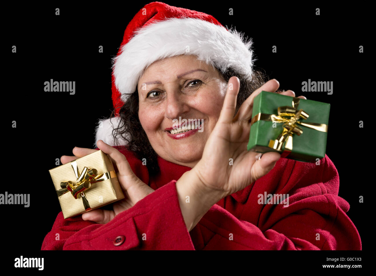Smiling Female Senior Showing Two Wrapped Gifts Stock Photo