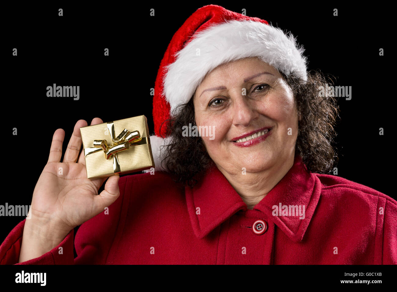 Smiling Senior Shows Golden Wrapped Christmas Gift Stock Photo