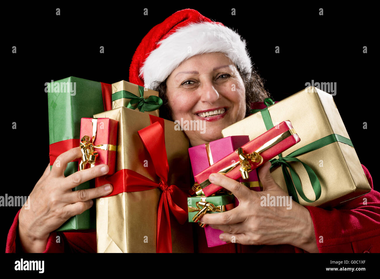 Joyful Senior Woman Hugging Eight Wrapped Gifts Stock Photo