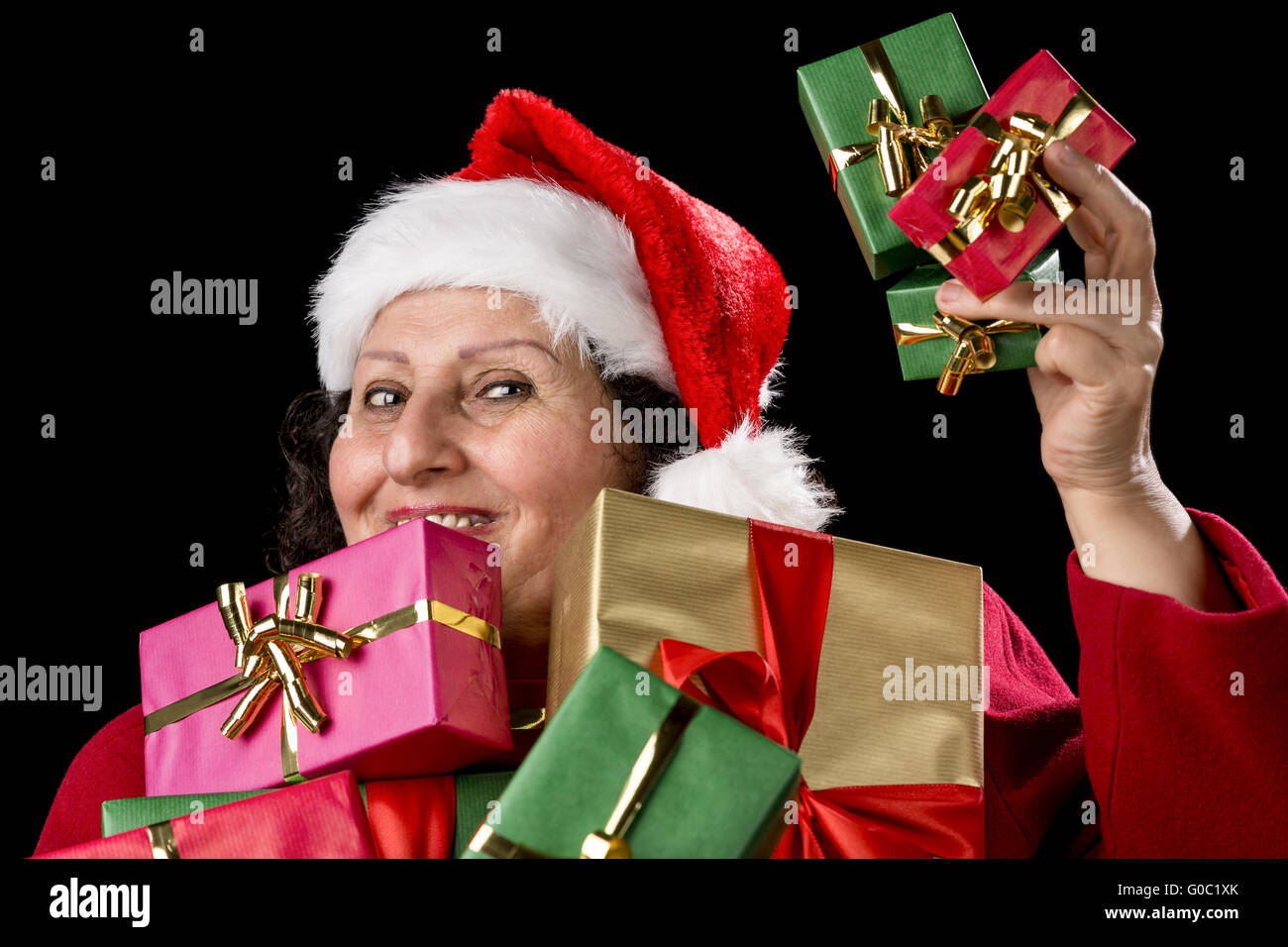 Perky Female Pensioner Presenting Wrapped Gifts Stock Photo
