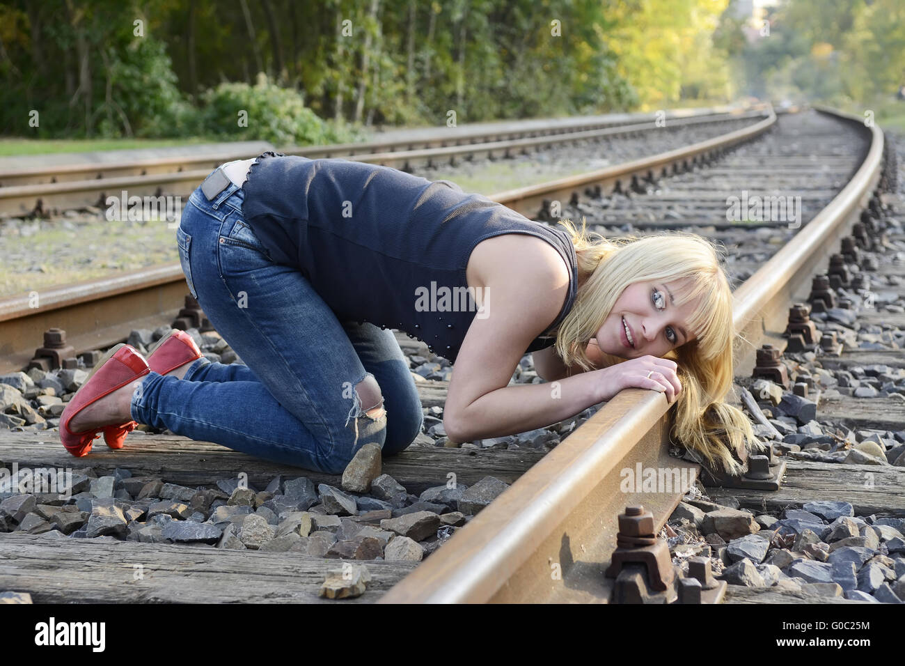 woman listening to rail track Stock Photo