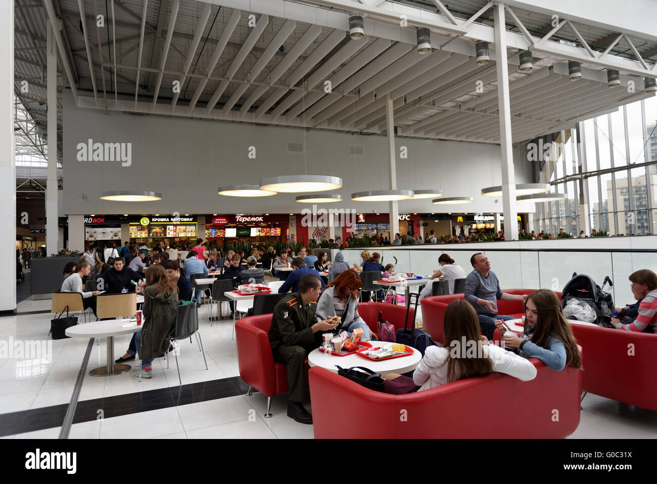 People resting on the food court of the shopping mall Pearl Plaza in St. Petersburg, Russia Stock Photo
