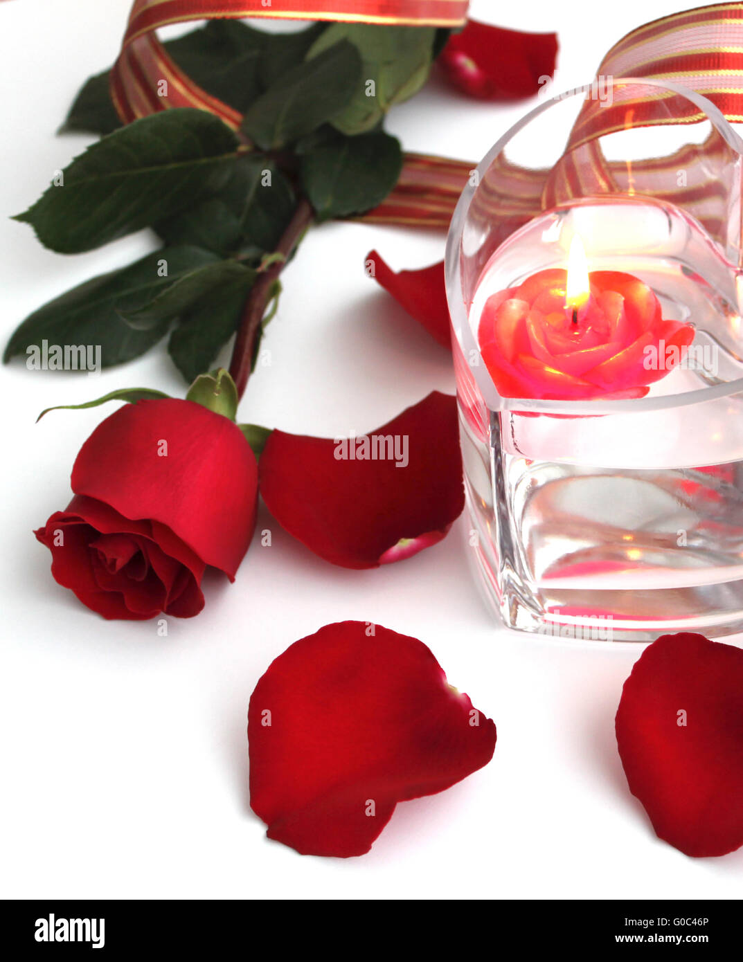 Beautiful red rose and red candle Stock Photo