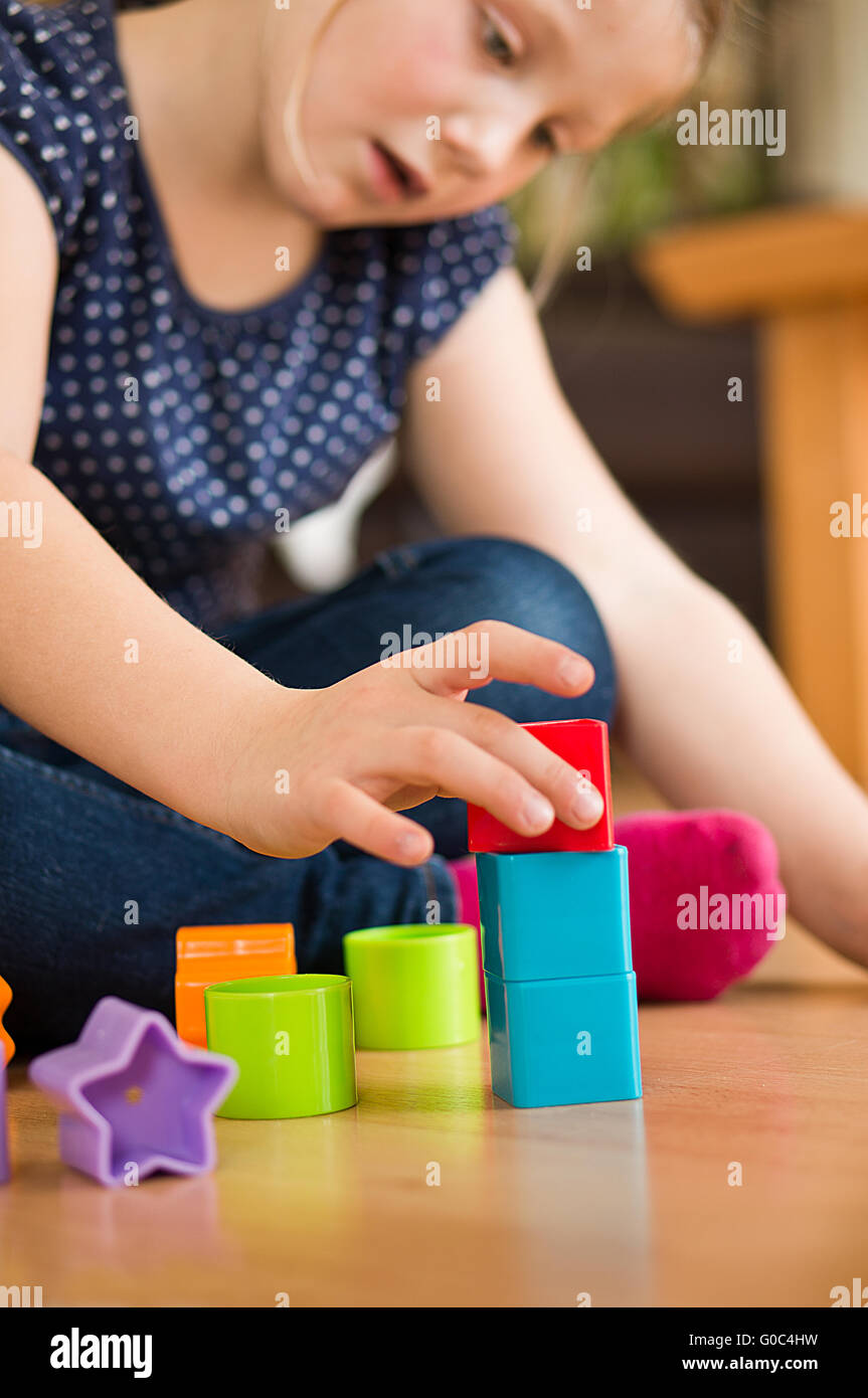 girl plays with brick Stock Photo