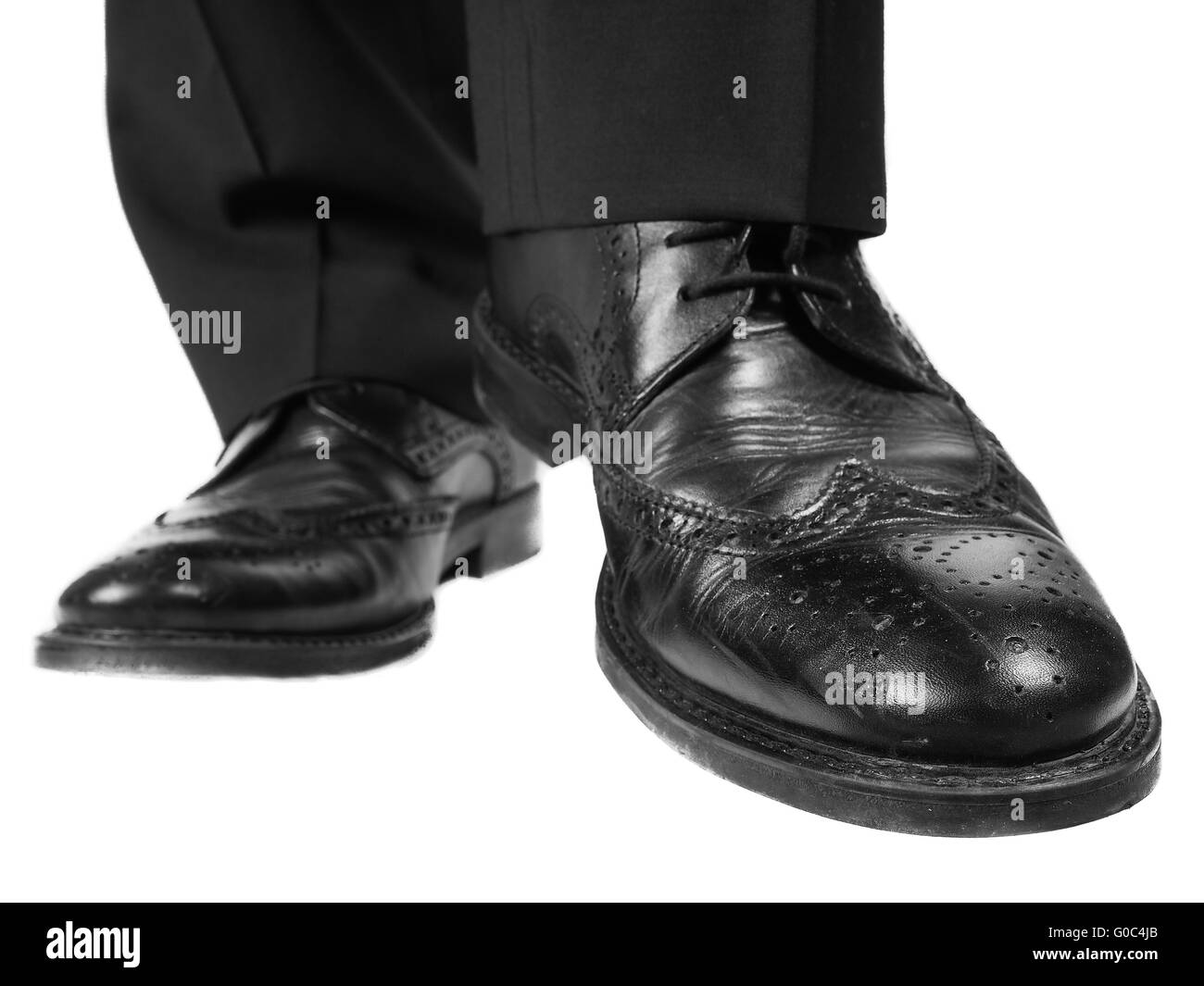 Black suit, black leather shoes approaching Stock Photo