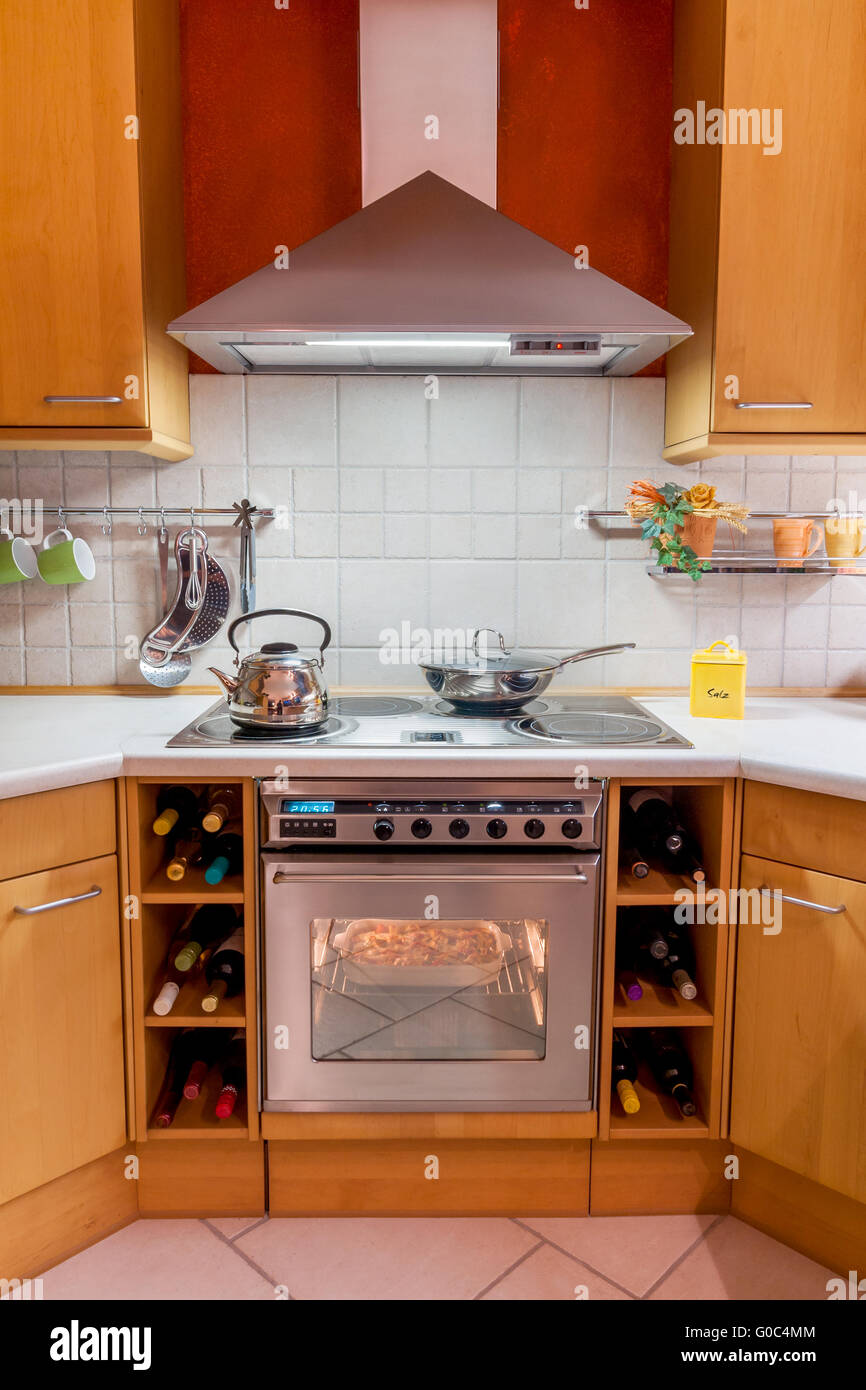 a kitchen with some uts hanging on the wall and an oven hood in the window  over the stovetop Stock Photo - Alamy