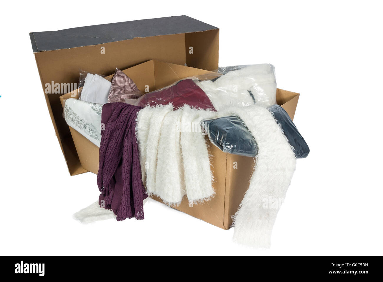 Cardboard with various packed and unpacked clothes Stock Photo