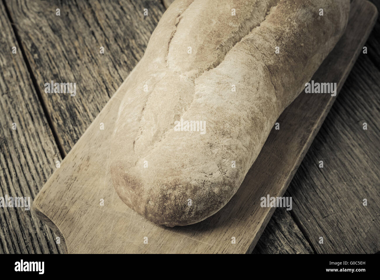 Bread on a Bread Board with Rustic Wood Background Stock Photo - Alamy