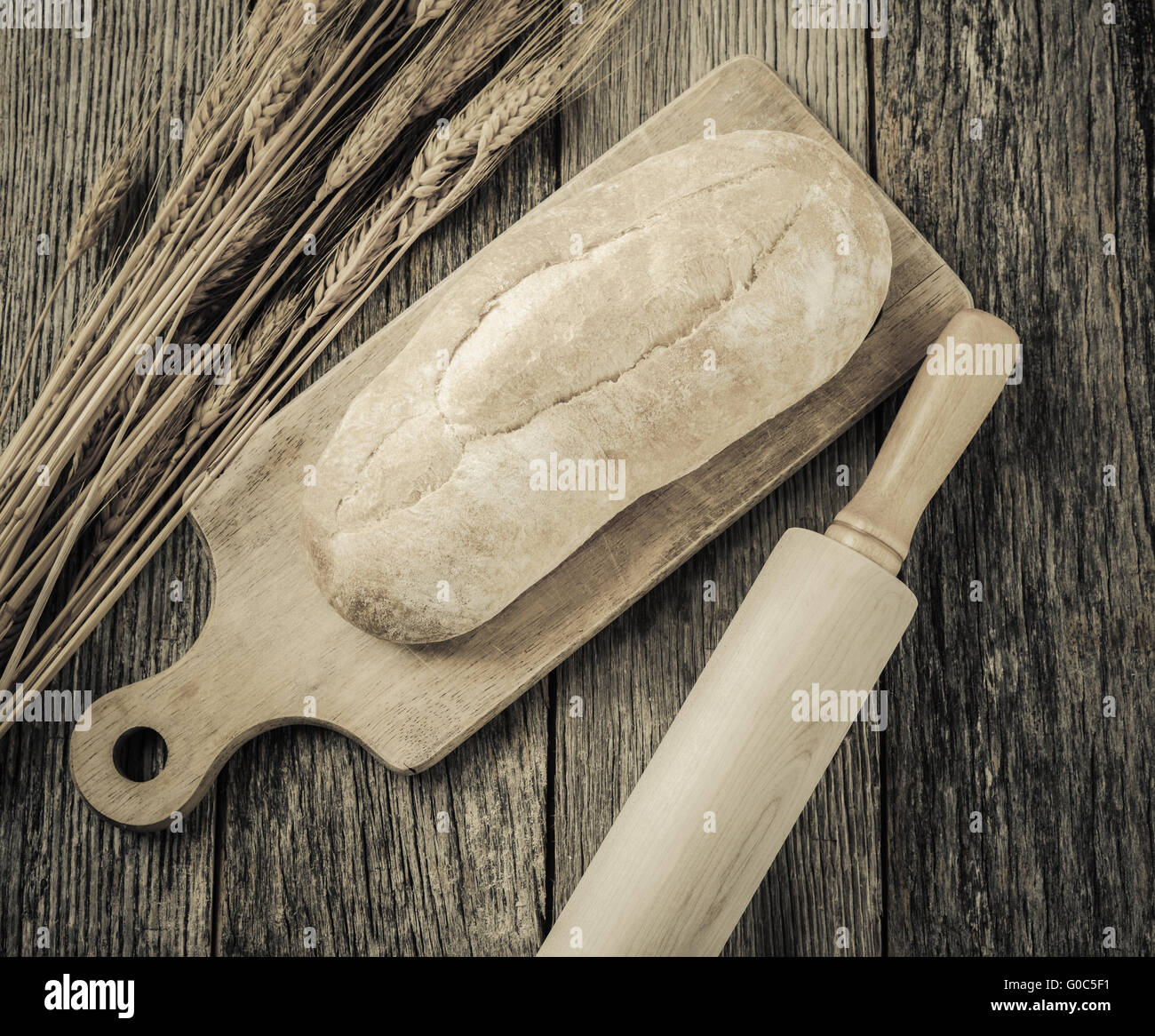 Fresh Bread with a Rolling Pin and Wheat on a Rustic Wood Table Stock ...