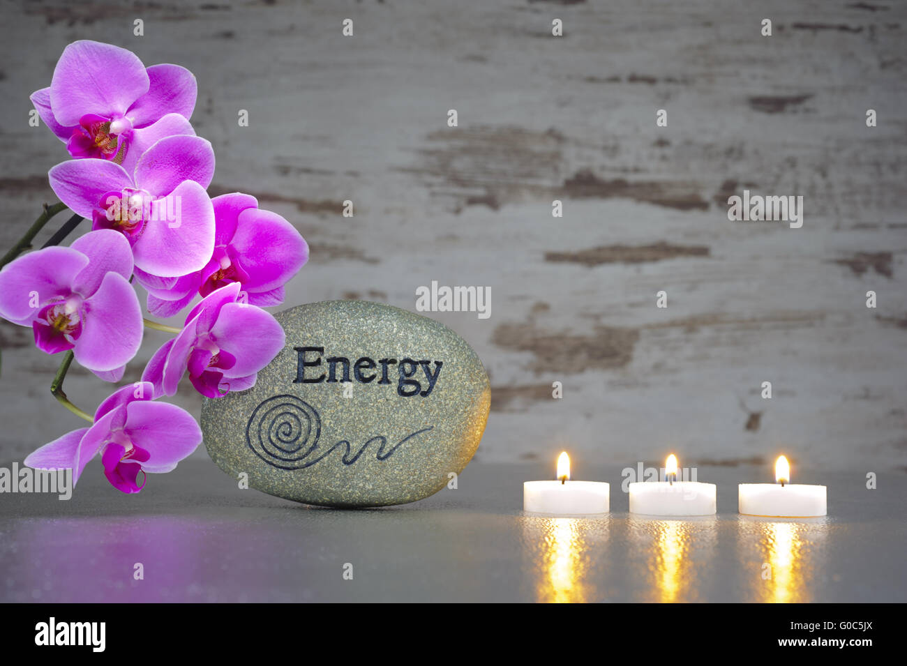 zen garden with stone of energy and candle lights Stock Photo