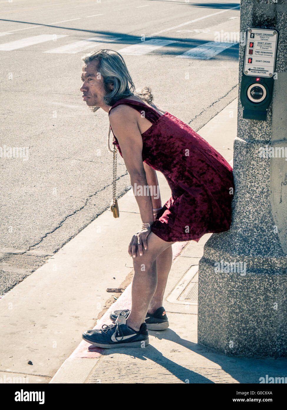 Transvestite observing street in L.A. Stock Photo