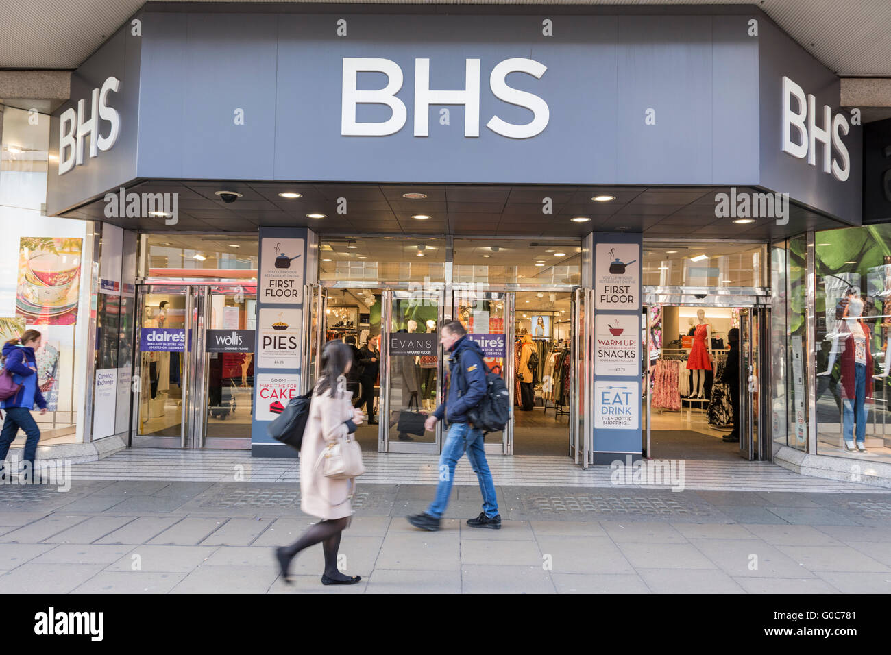 Shoppers pass in front of the former flagship BHS store on London's Oxford Street. Stock Photo