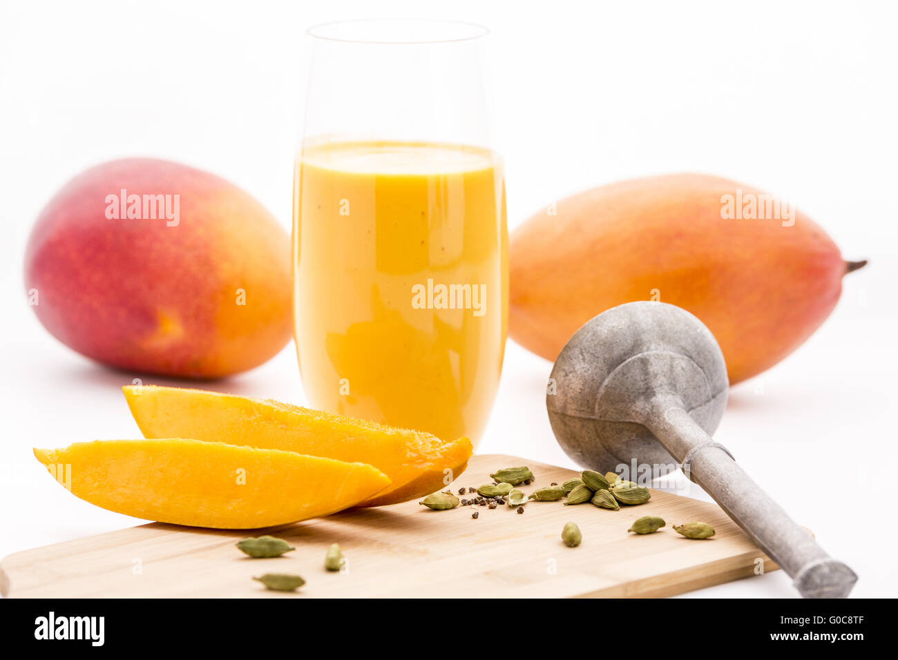 Crushed Cardamon, Pestle, Mangos And Mango Lassie Stock Photo Alamy