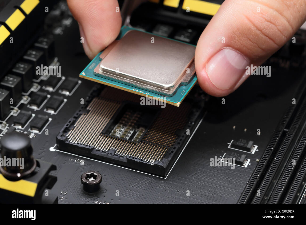Installing central processor unit into motherboard Stock Photo
