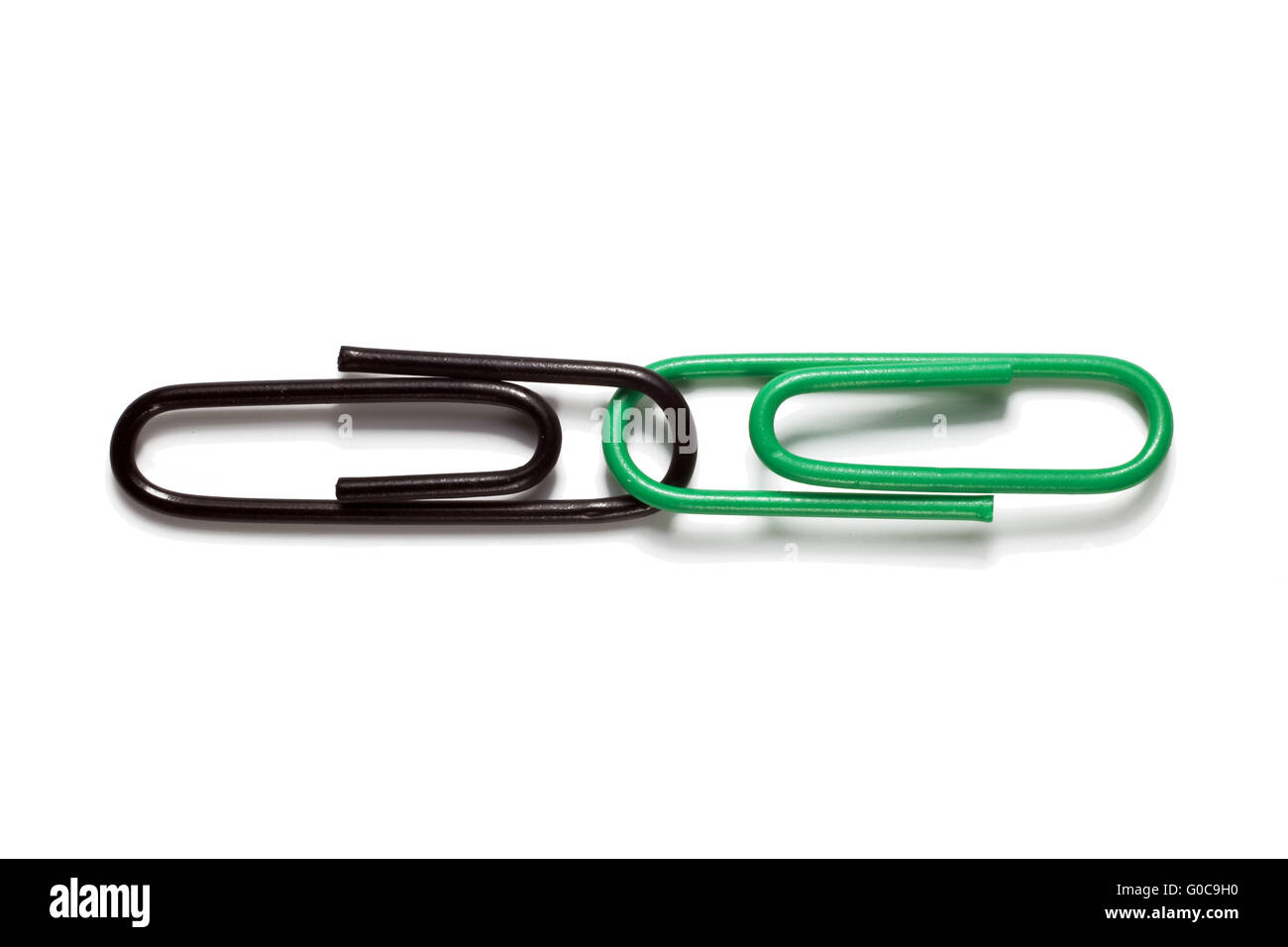 Black and green paper clips, symbolic image Stock Photo Alamy