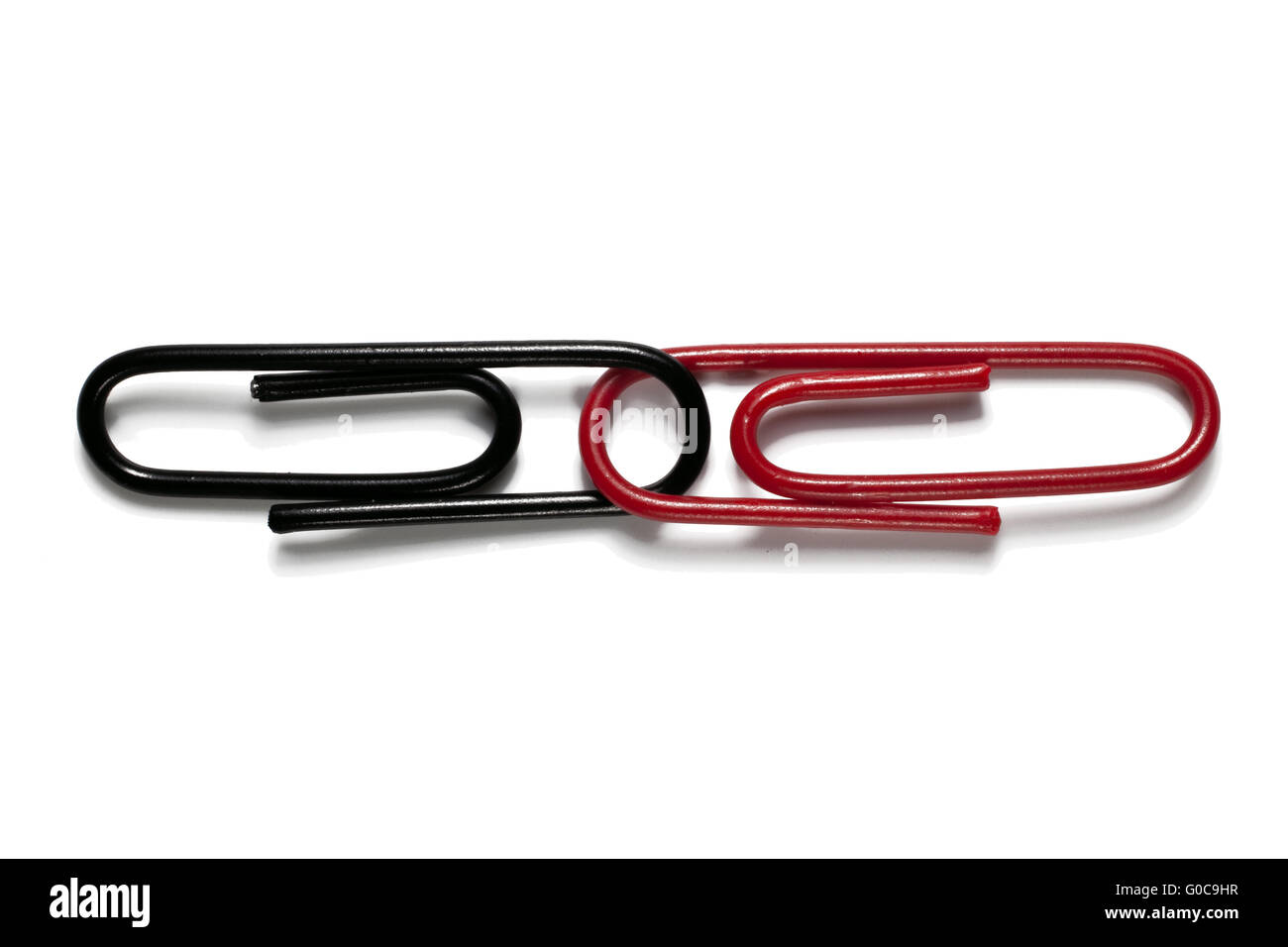 Black and red paper clips, symbolic image Stock Photo