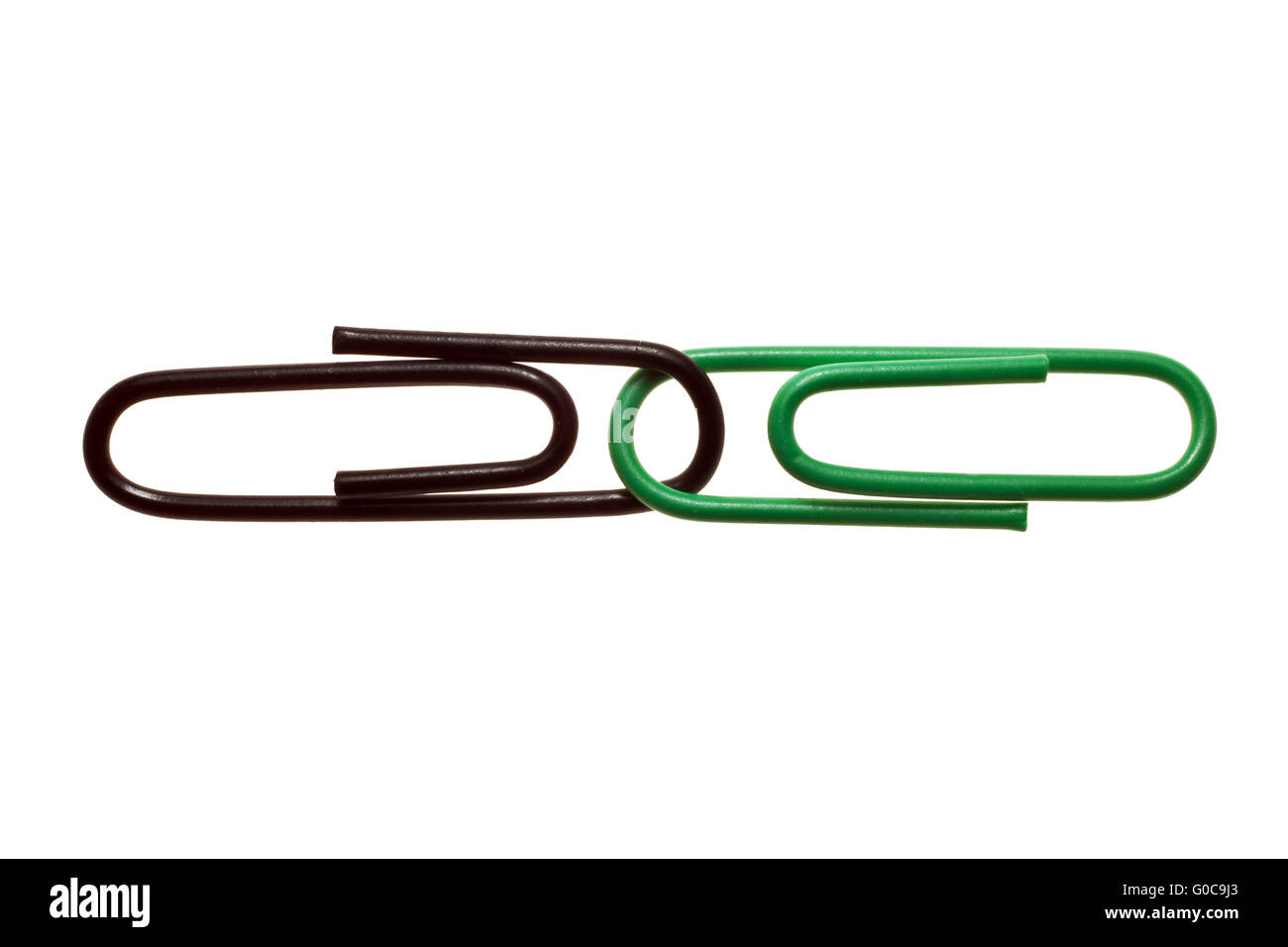 Black and green paper clips, symbolic image Stock Photo