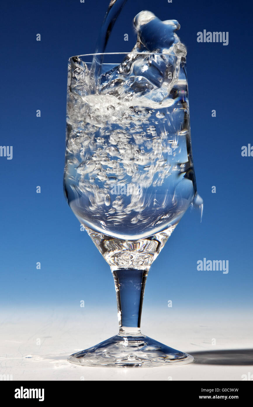 Water is being poured into a glass Stock Photo