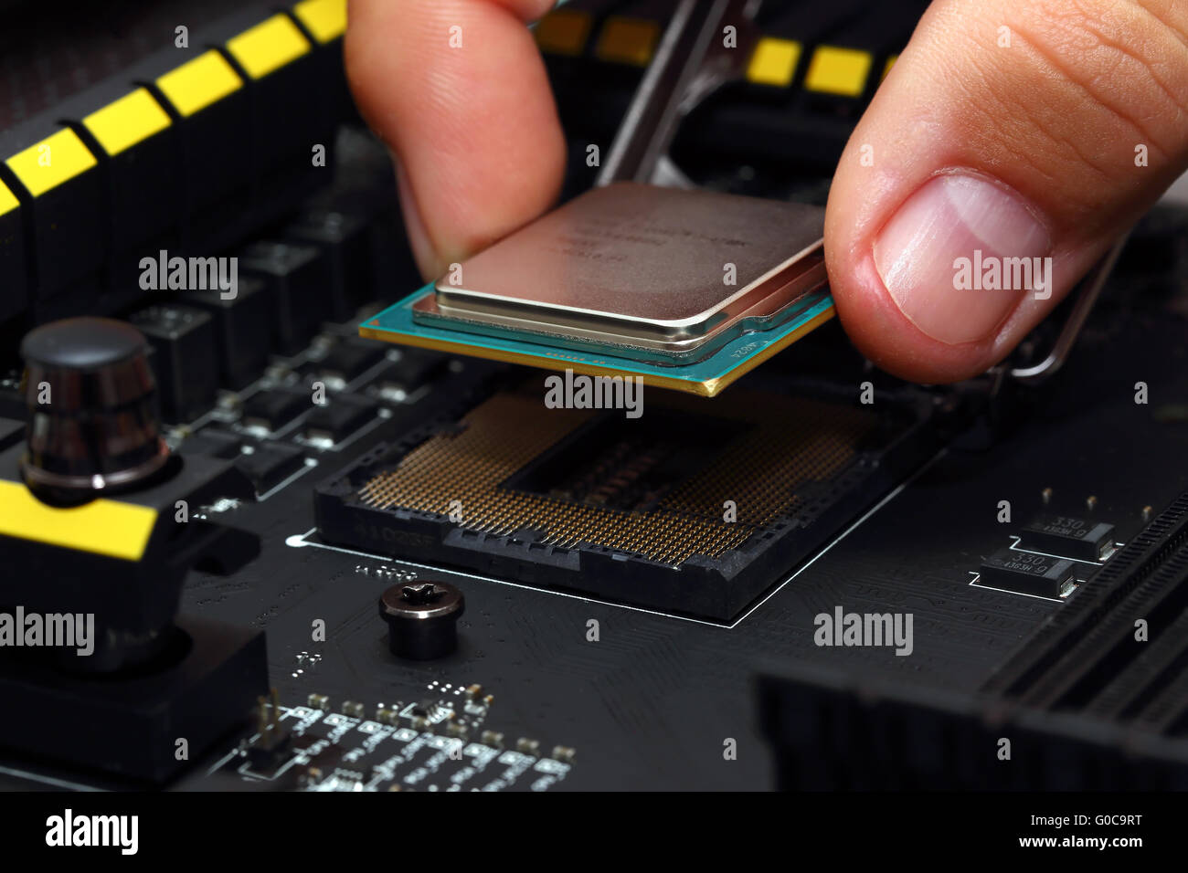 Installing central processor unit into motherboard Stock Photo