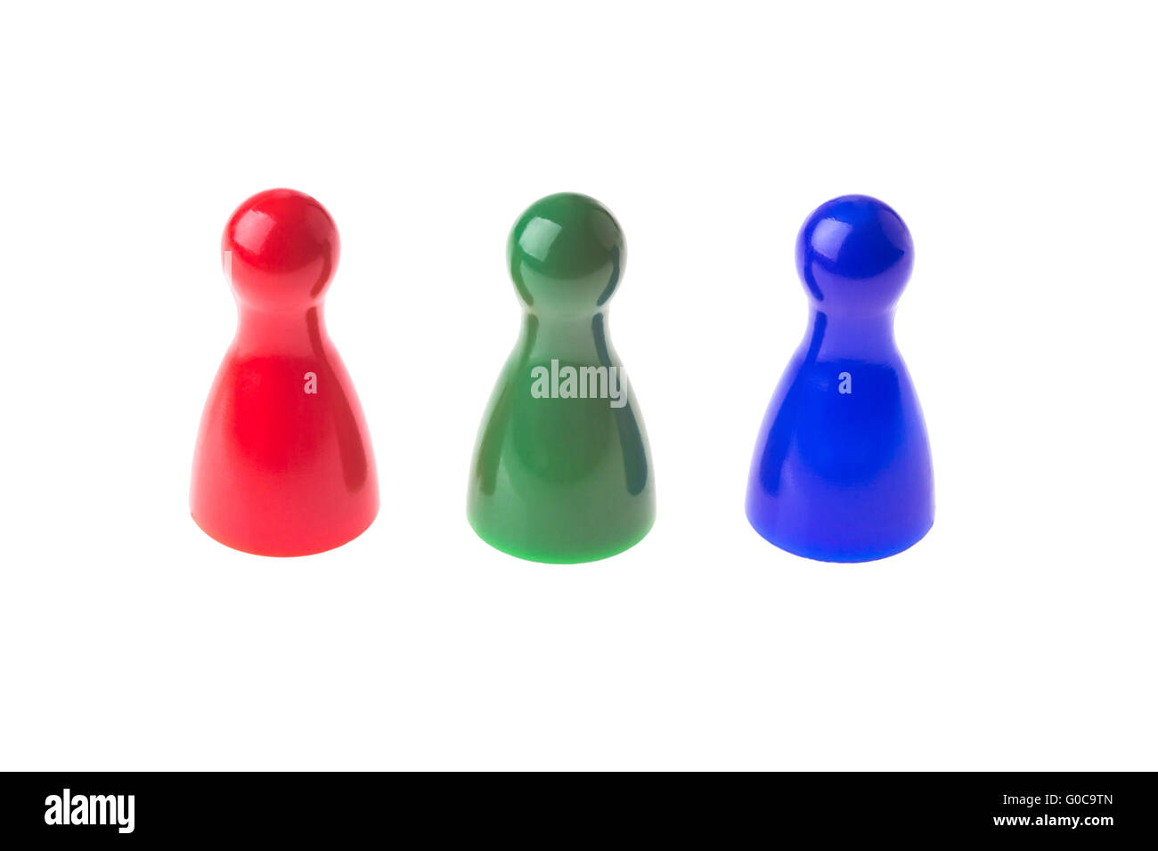Three game pawns in a row in different colors Stock Photo