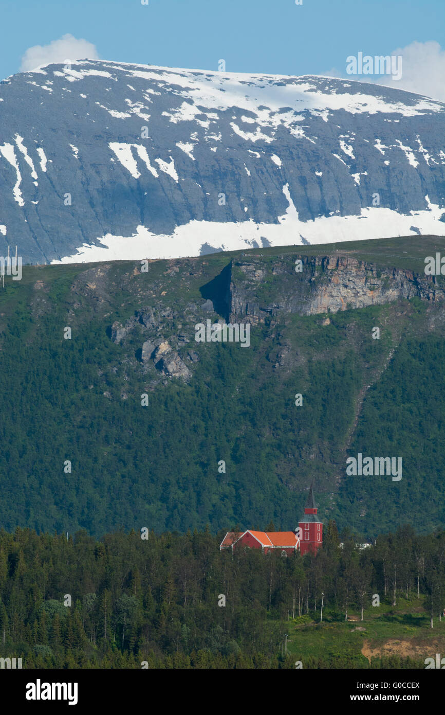 Norway, Tromso. Old red church in mountain setting. Stock Photo