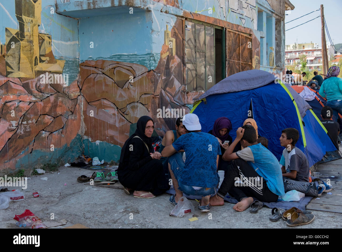 Syrian refugee family takes temporary shelter in a tent in the harbor of Mytillene, Lesvos while awaiting their asylum request. Stock Photo