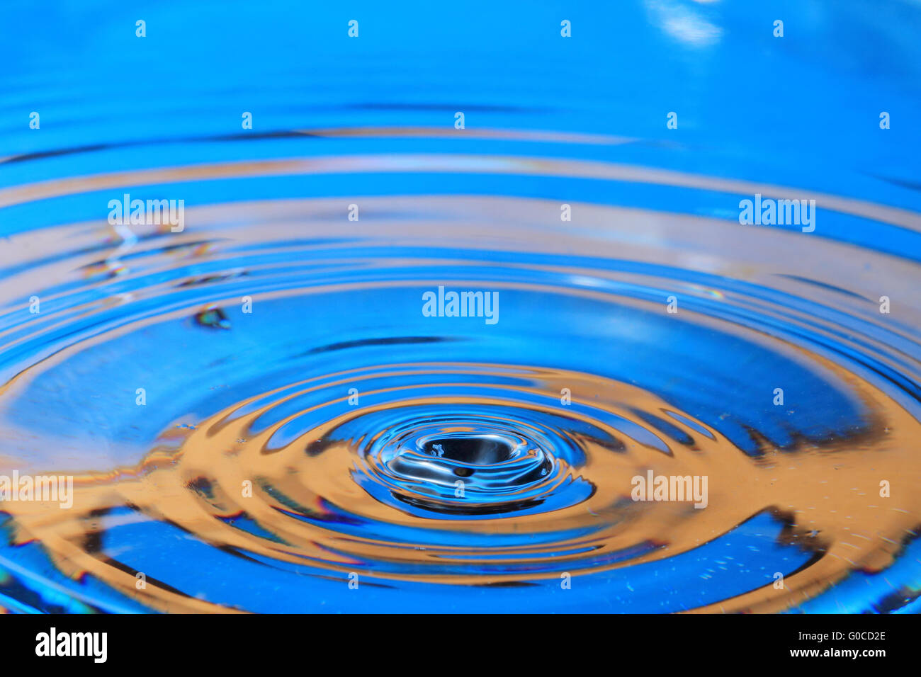 Blue orange water drop splashing with waves Stock Photo Alamy