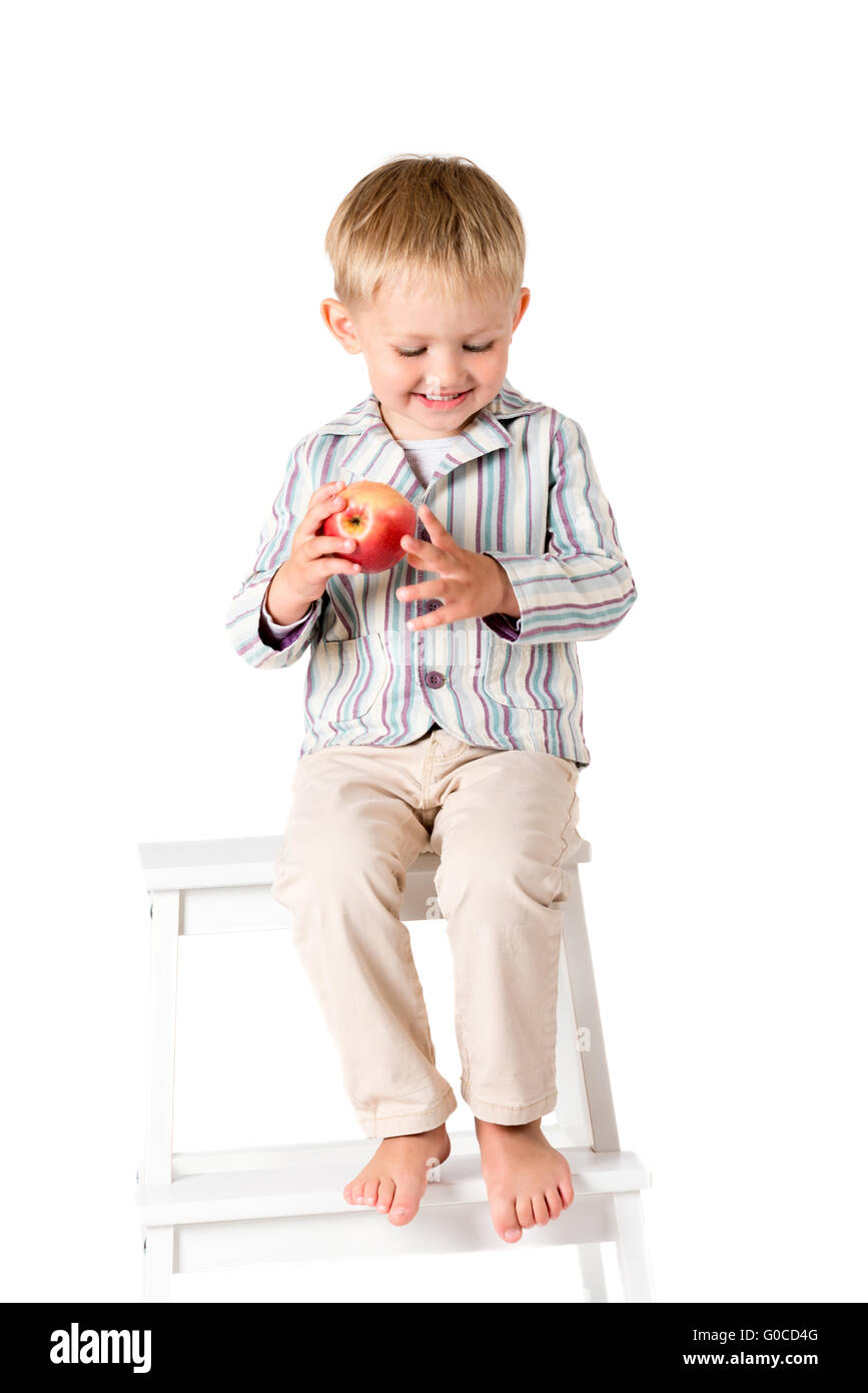 Boy shot in the studio on a white background smiling sitting Stock Photo