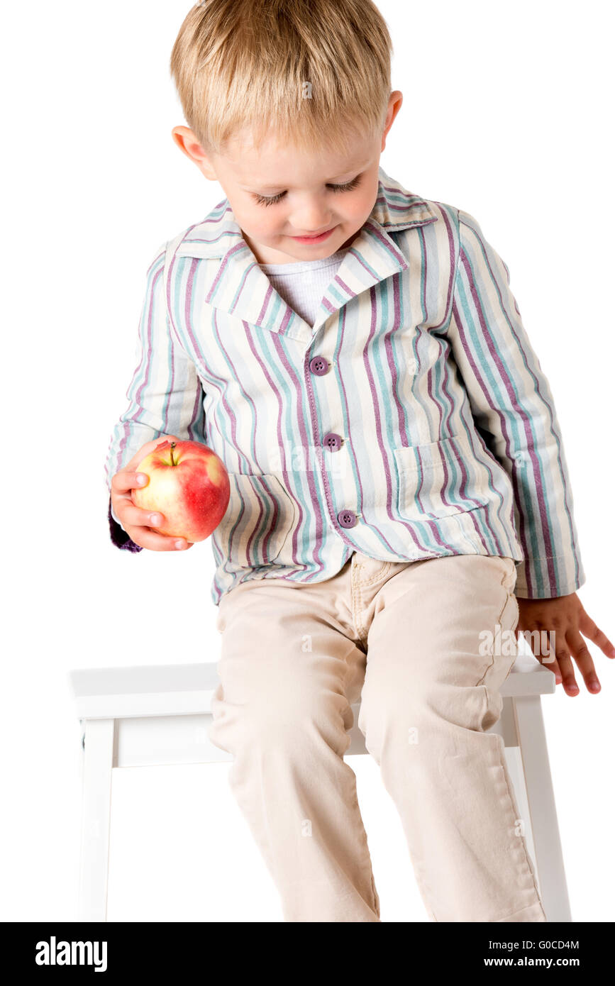 Boy shot in the studio on a white background on stool Stock Photo