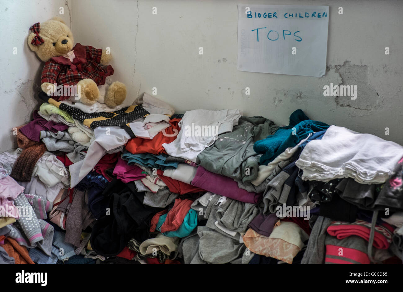 Storage of clothes for refugees in a warehouse on the Greek island of Lesvos with clothing for children Stock Photo
