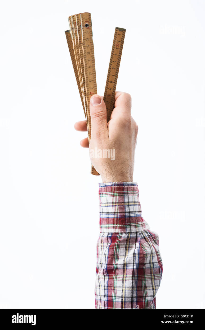 Male carpenter's hand holding a folding ruler on white background Stock ...