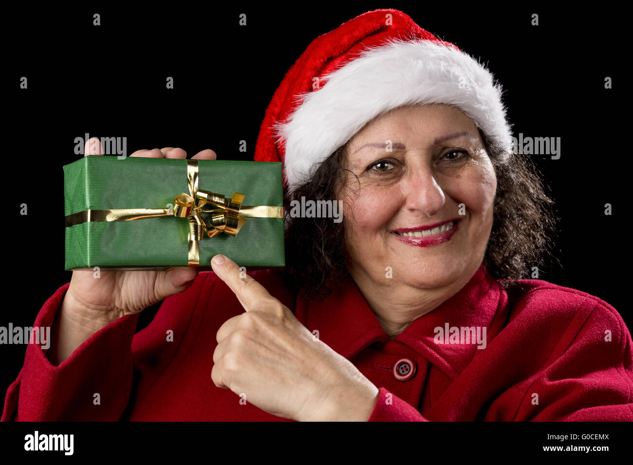 Female Senior Pointing at Green Wrapped Present Stock Photo