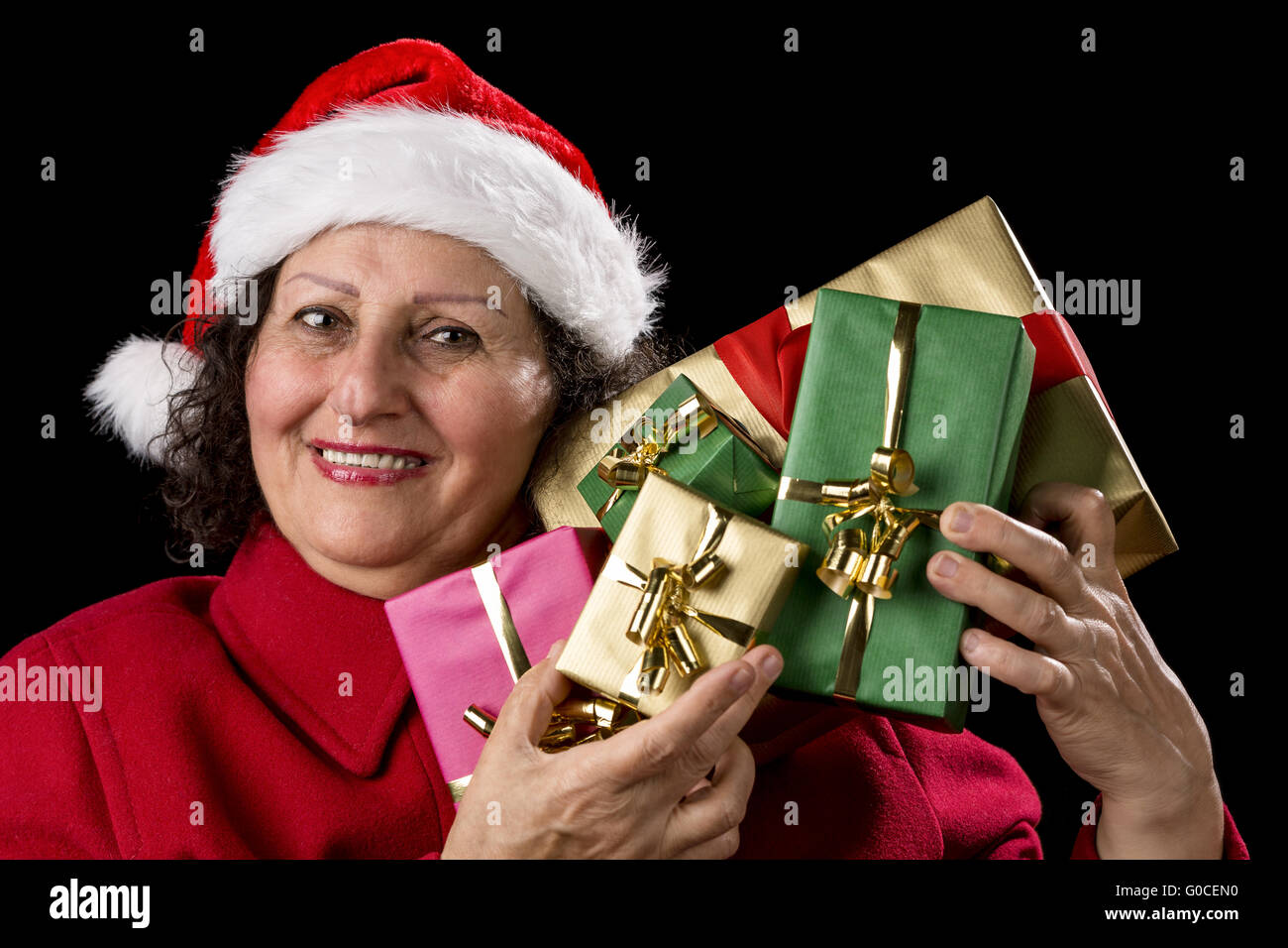 Mature Lady Holding Up Five Christmas Presents Stock Photo