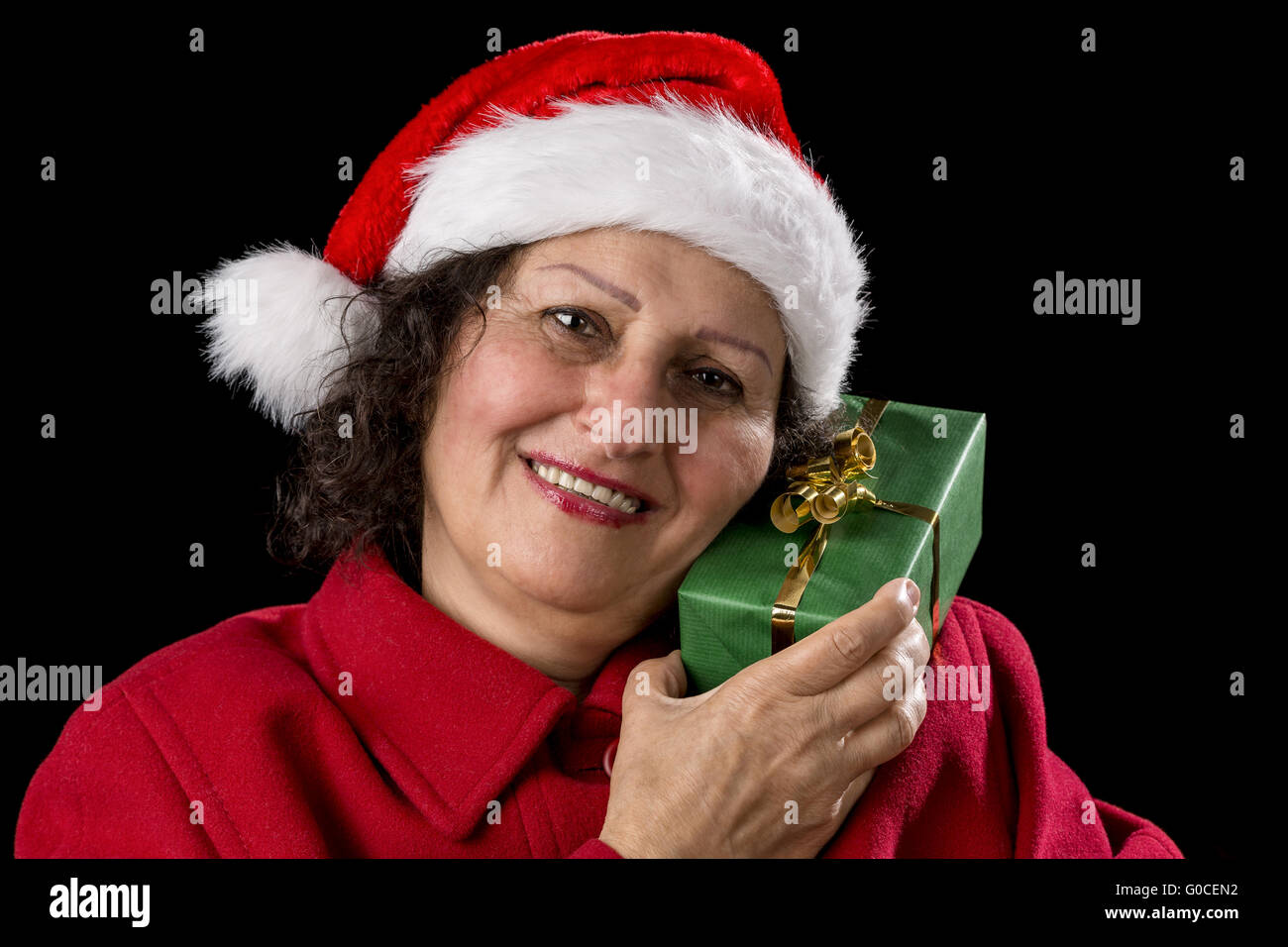 Senior Lady with Santa Claus Hat and Wrapped Gift Stock Photo
