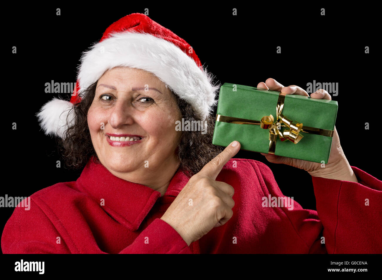 Smiling Mature Woman Pointing at Wrapped Xmas Gift Stock Photo