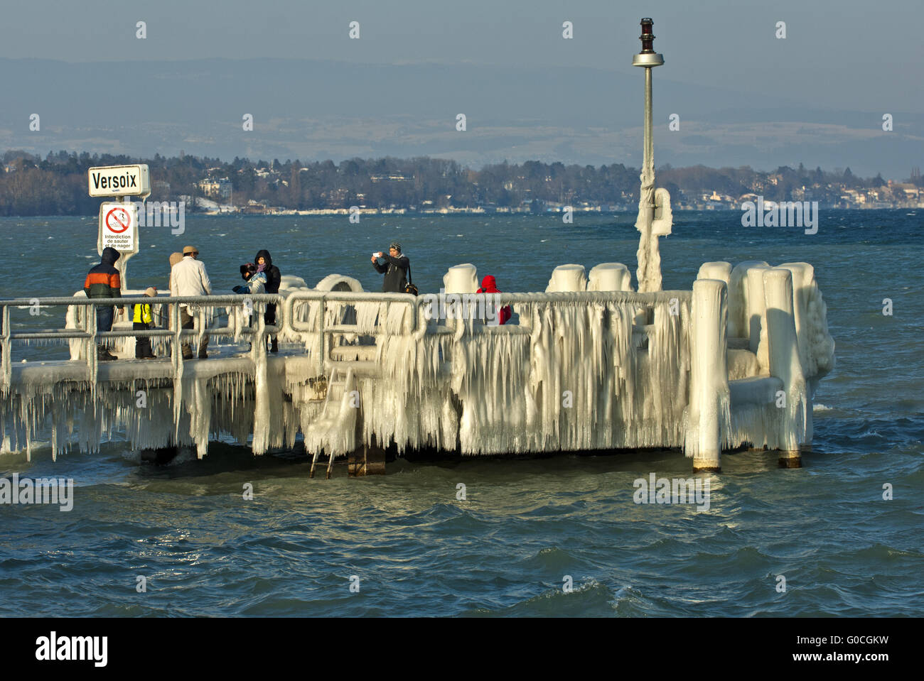 Ice-covered jetty in the Lake Geneva Stock Photo