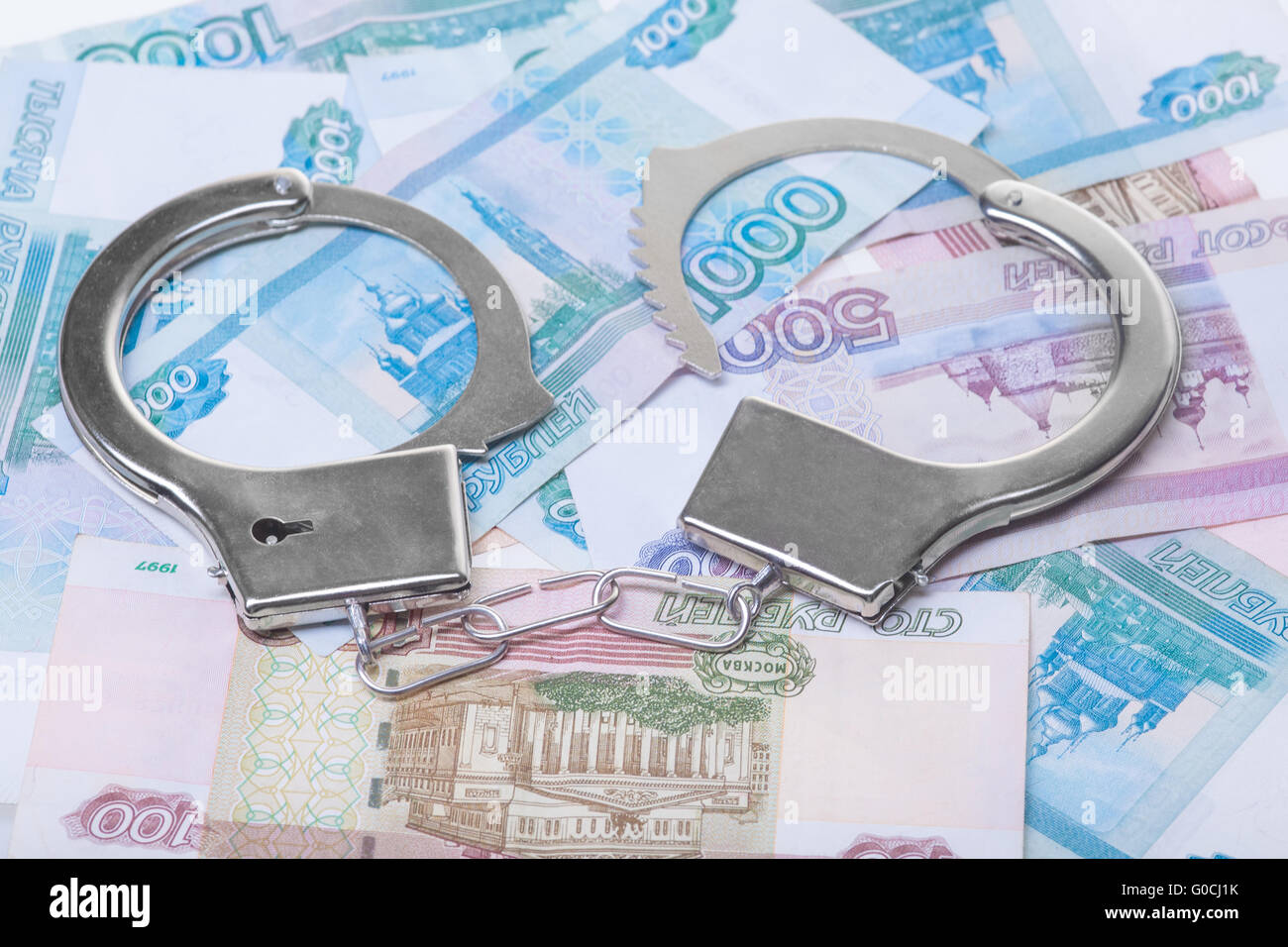 handcuffs and money isolated Stock Photo