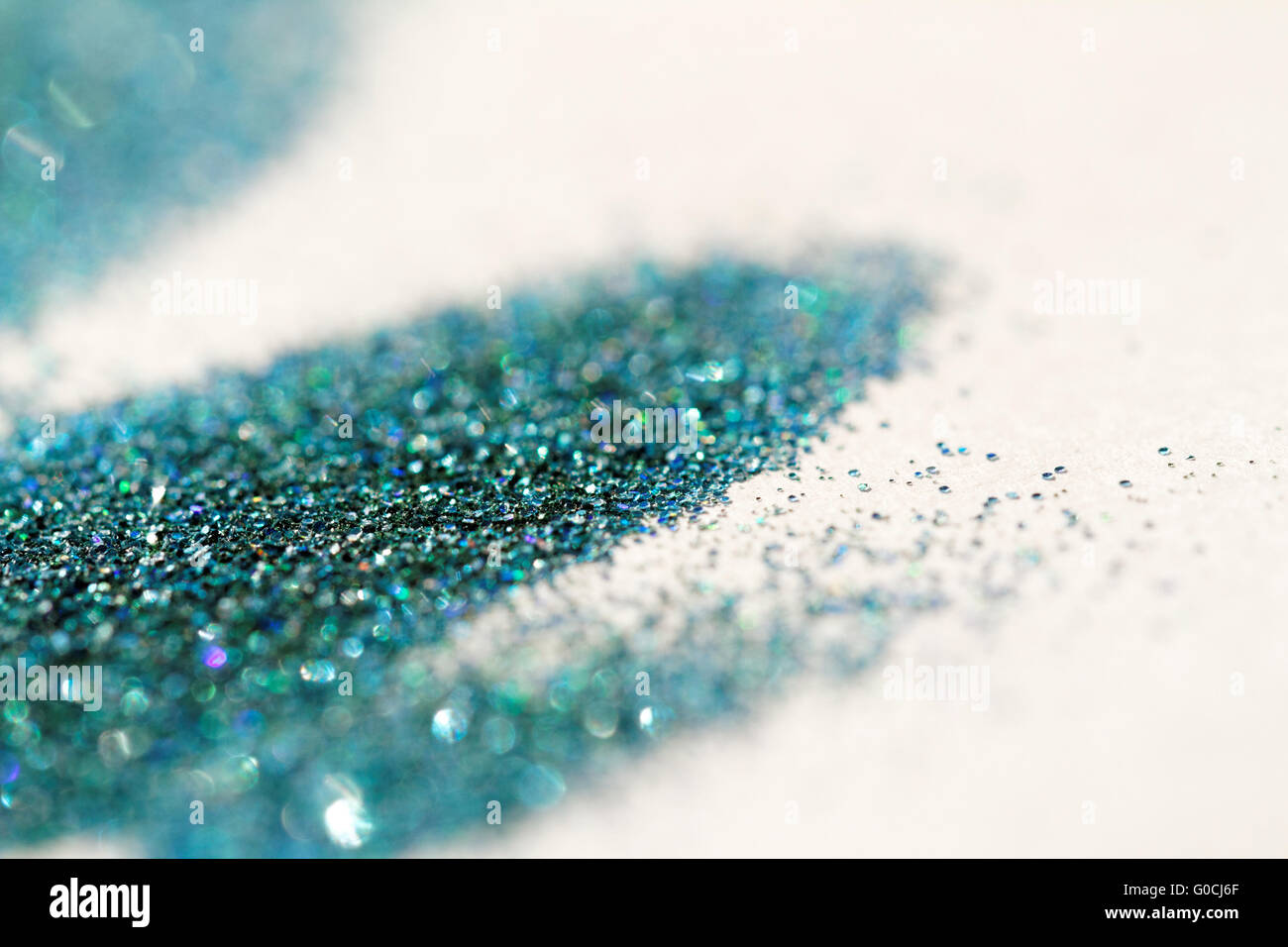 Turquoise glitter on light background - macro photo Stock Photo