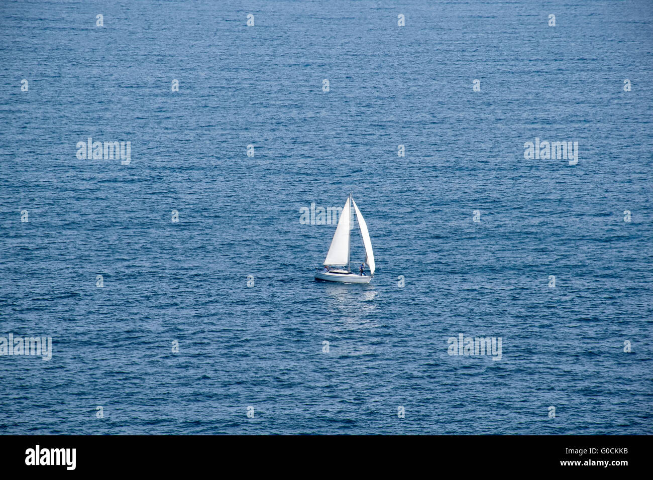 A sailing boat in the blue sea Stock Photo - Alamy