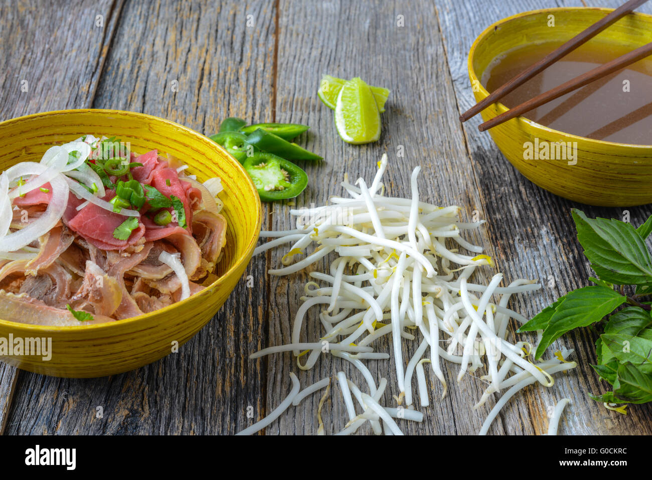 Pho Vietnamese beef soup on a wooden background Stock Photo - Alamy
