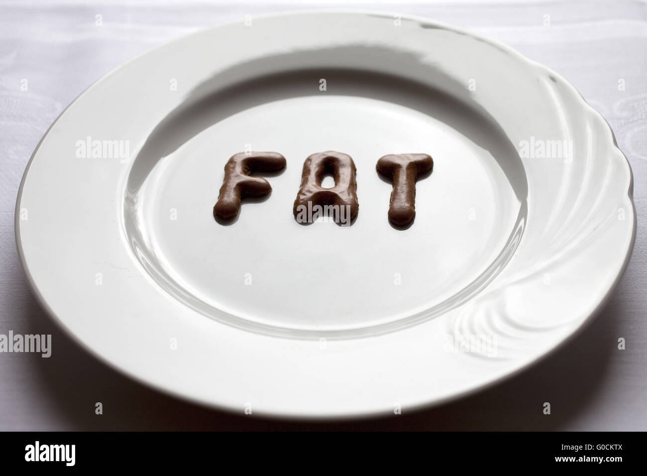 Letters forming the word fat on a plate Stock Photo Alamy