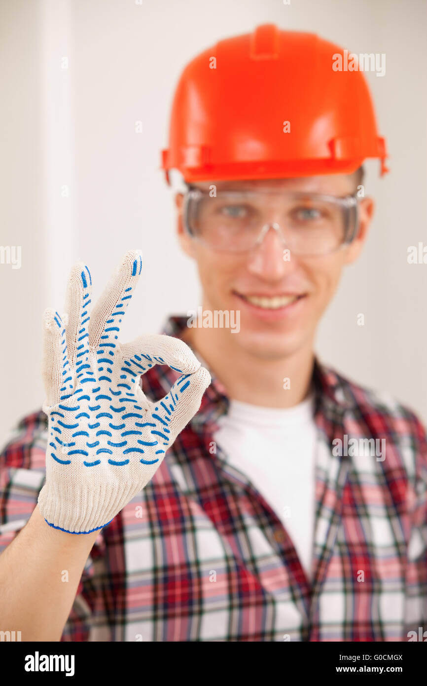repairman making a perfect gesture with his gloved Stock Photo