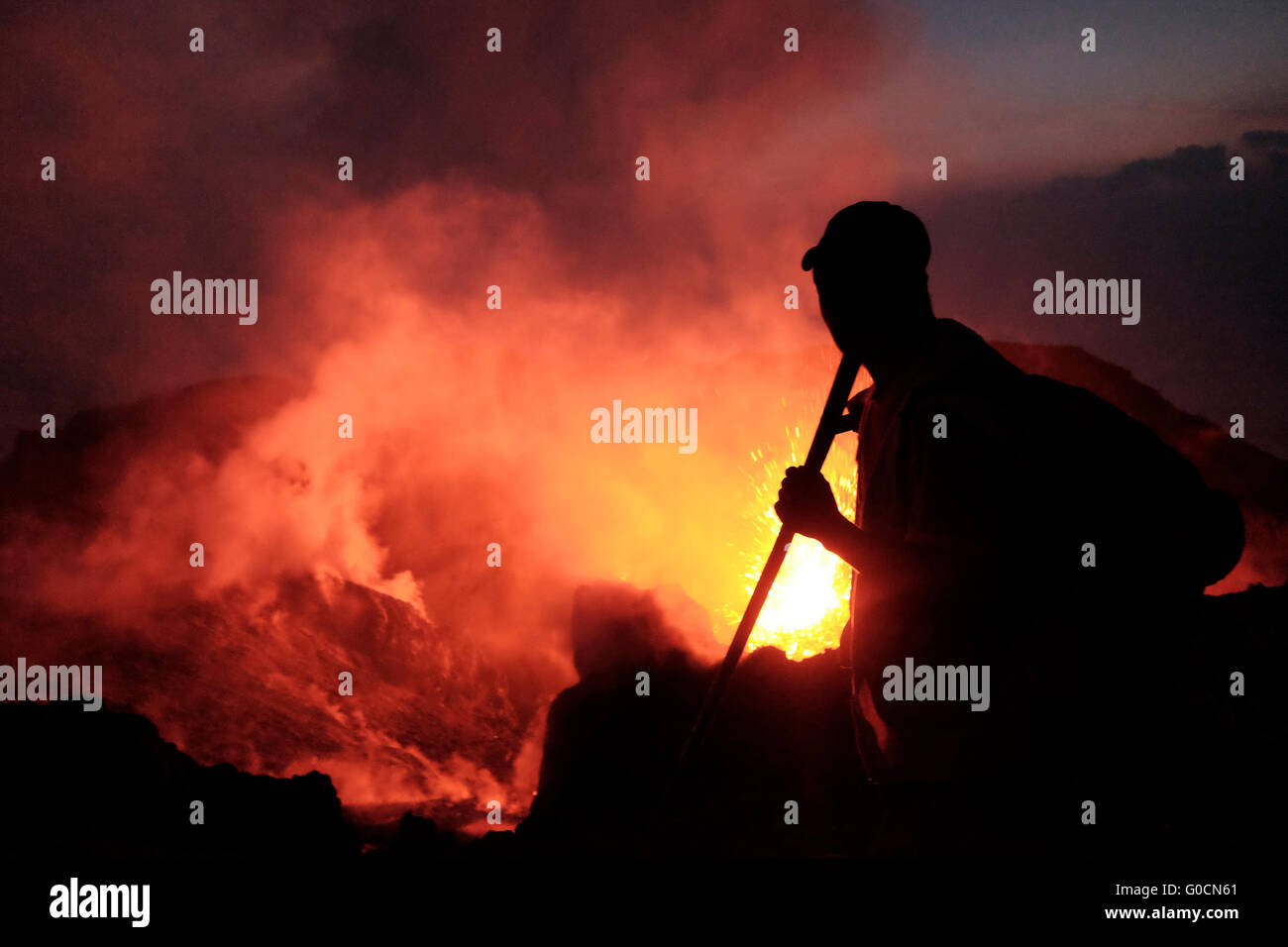 A man gazing at a volcanic eruption from the crater of the Pacaya an ...