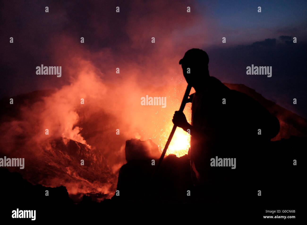 A man looks at a volcanic eruption from the crater of the Pacaya an ...