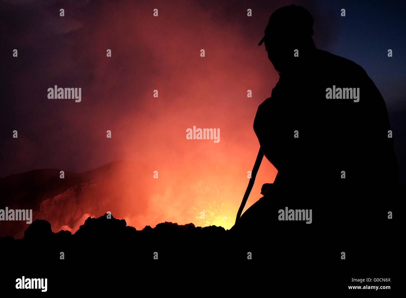 A man looks at a volcanic eruption from the crater of the Pacaya an ...