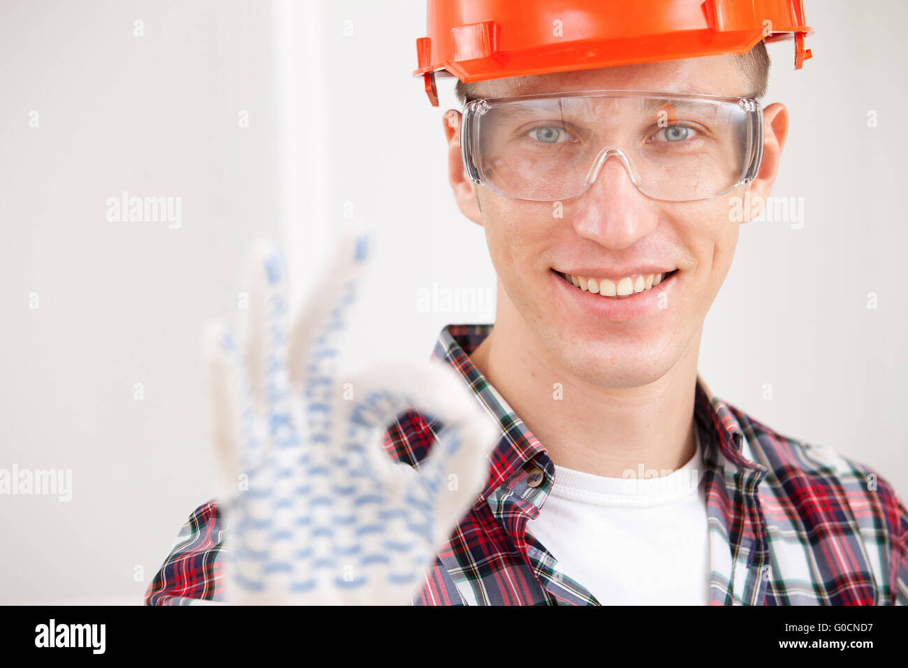 repairman making a perfect gesture with his gloved Stock Photo